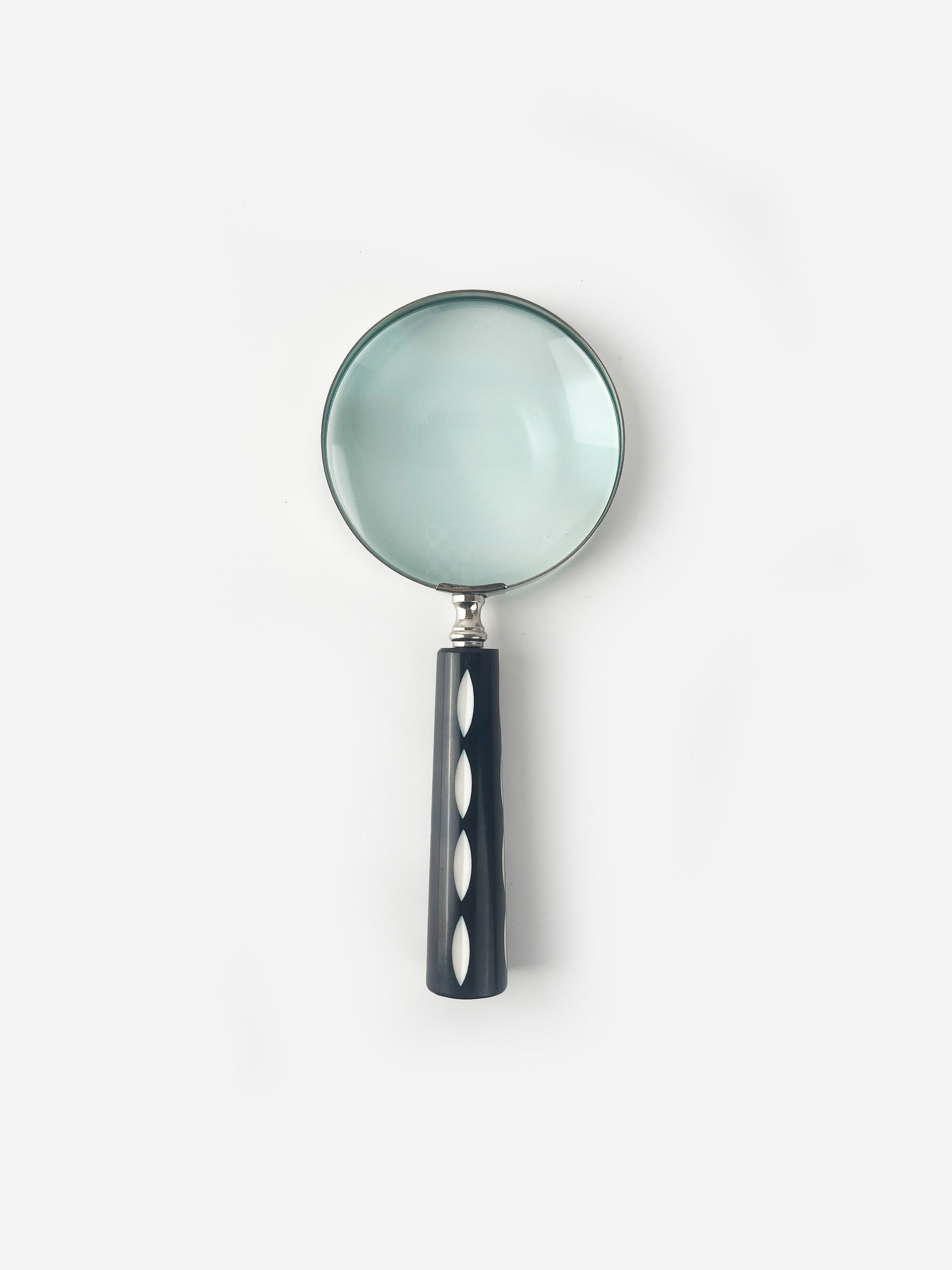 Magnifying glass with black and white spot handle